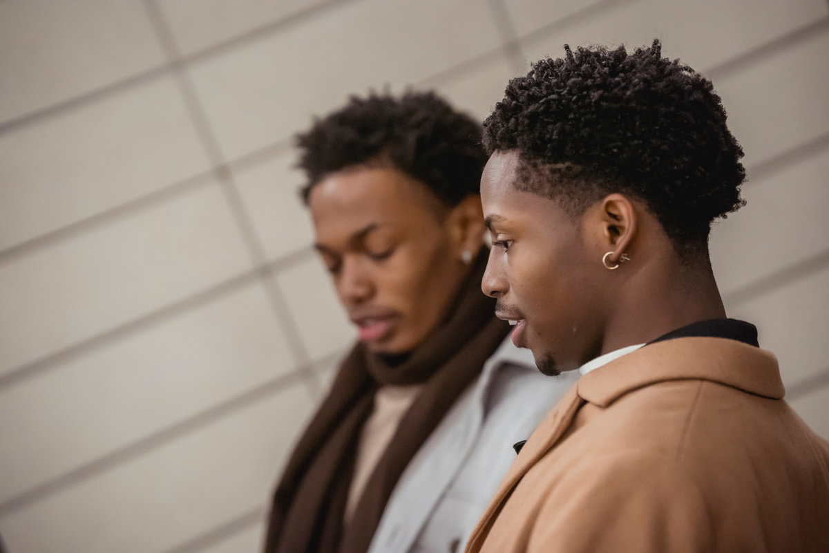 Black men in coats talking together